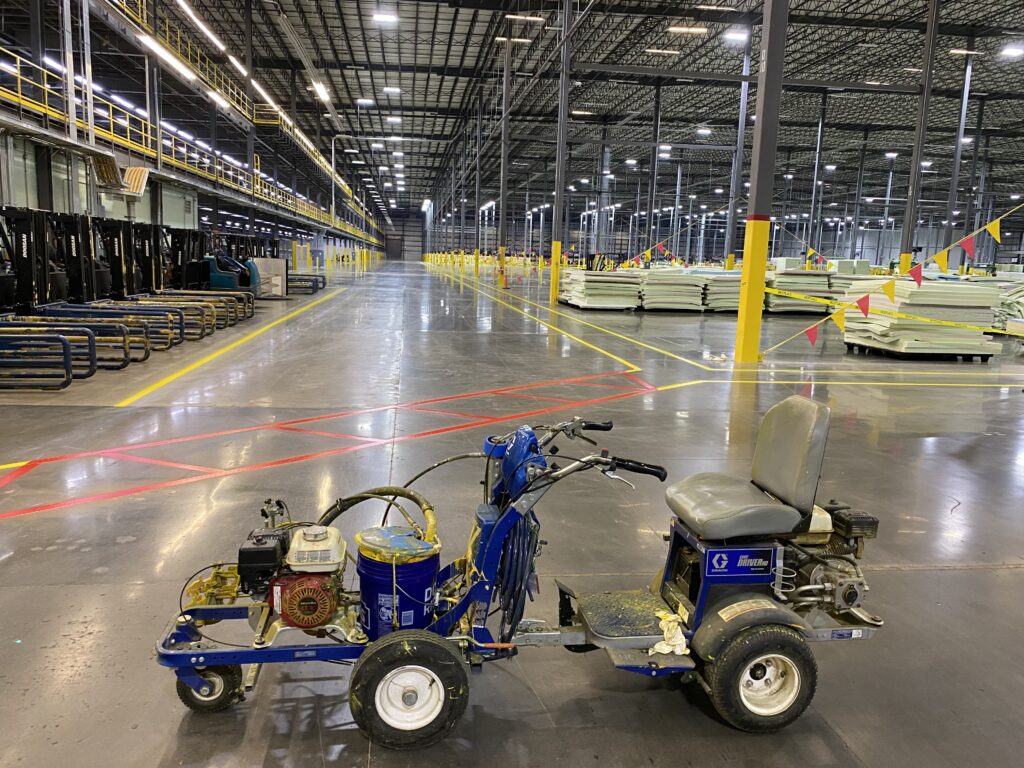 Warehouse with newly applied line striping for improved workflow and safety compliance