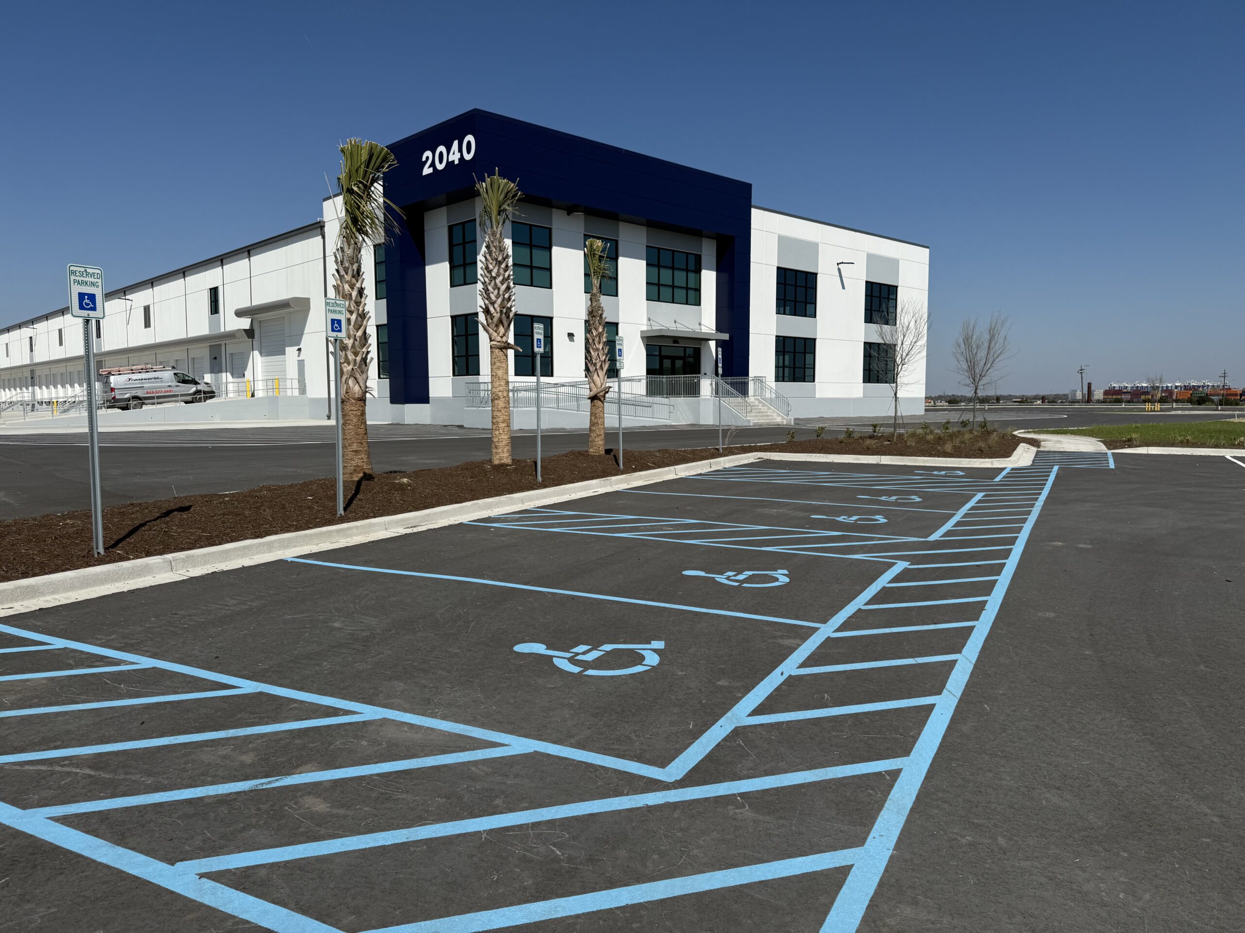 “Professional team applying high-quality line striping to a commercial parking lot.”
