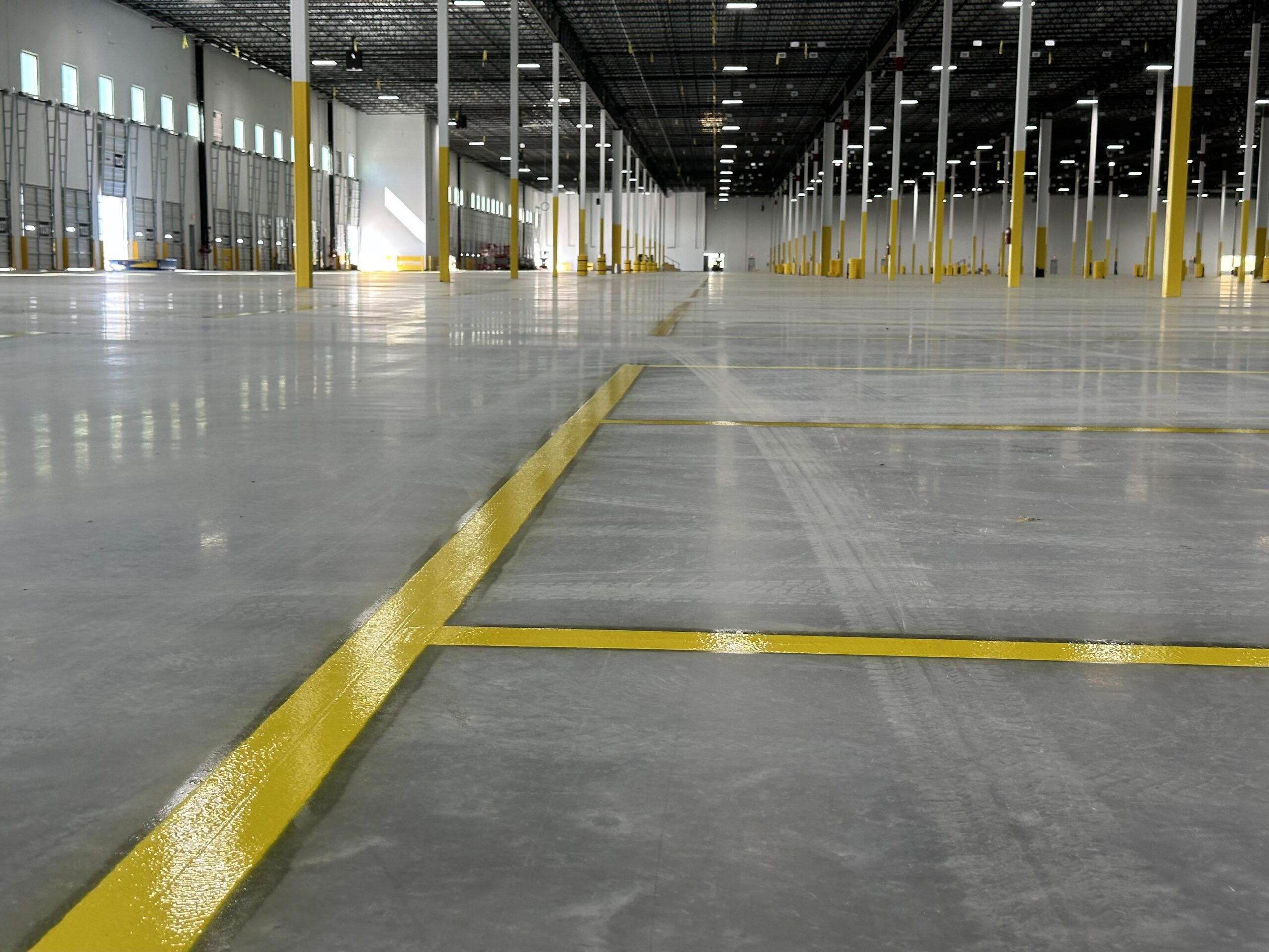 Universal Striping completing largescale warehouse epoxy striping in Kansas