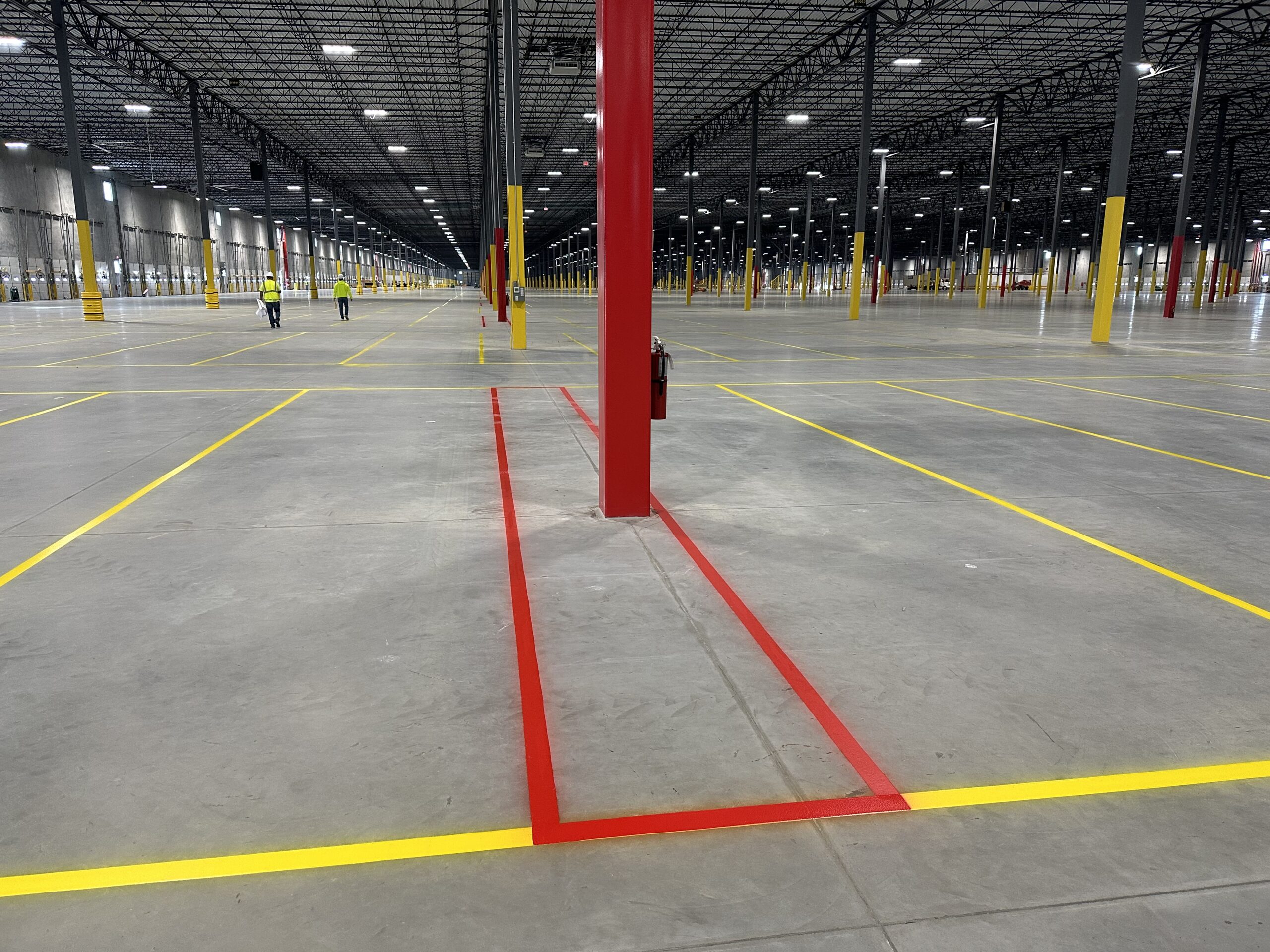 7. Professional warehouse floor striping in Michigan featuring rack aisles, crosswalks, and warehouse safety markings.