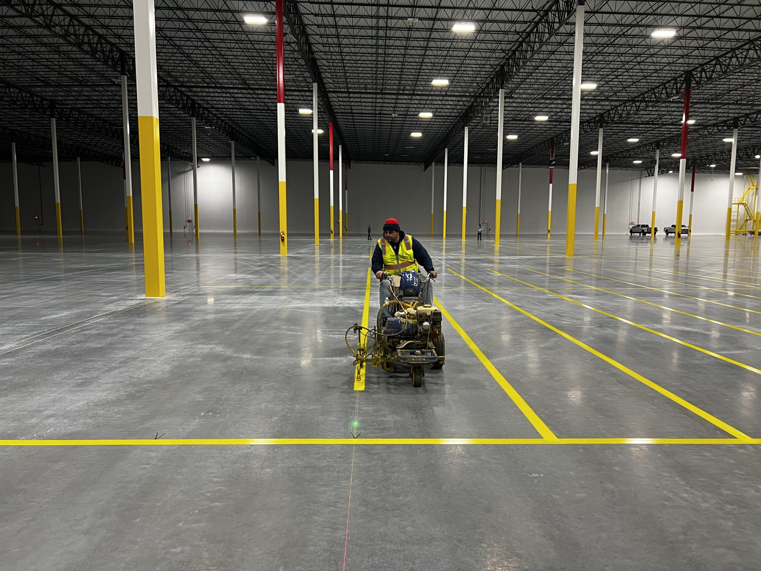 Freshly striped commercial parking lot featuring ADA parking spaces, fire lanes, and directional arrows in Phoenix AZ