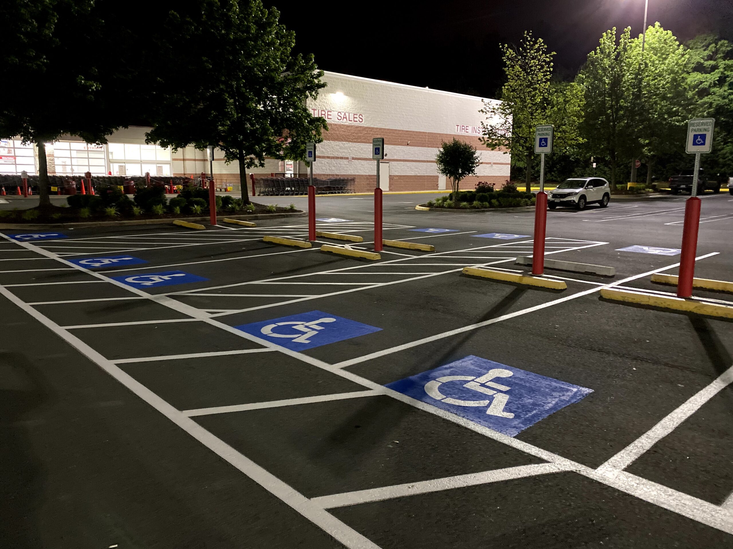 Commercial parking lot with accessible parking spaces at night