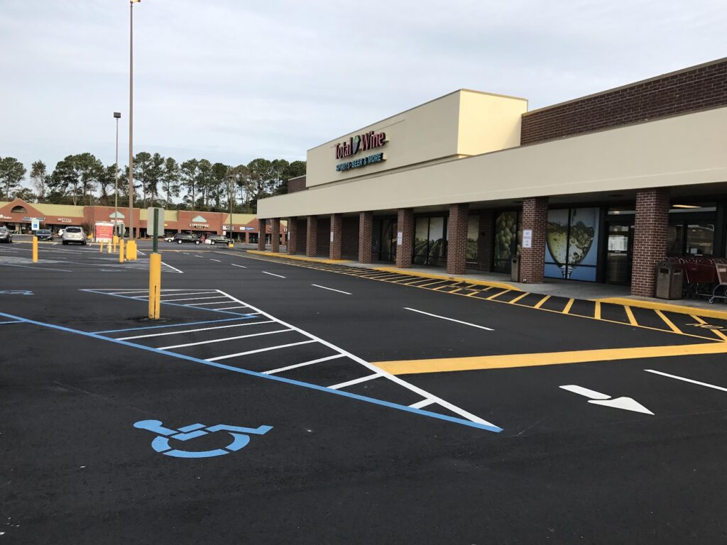 Freshly striped commercial parking lot with accessible parking spaces and pedestrian markings