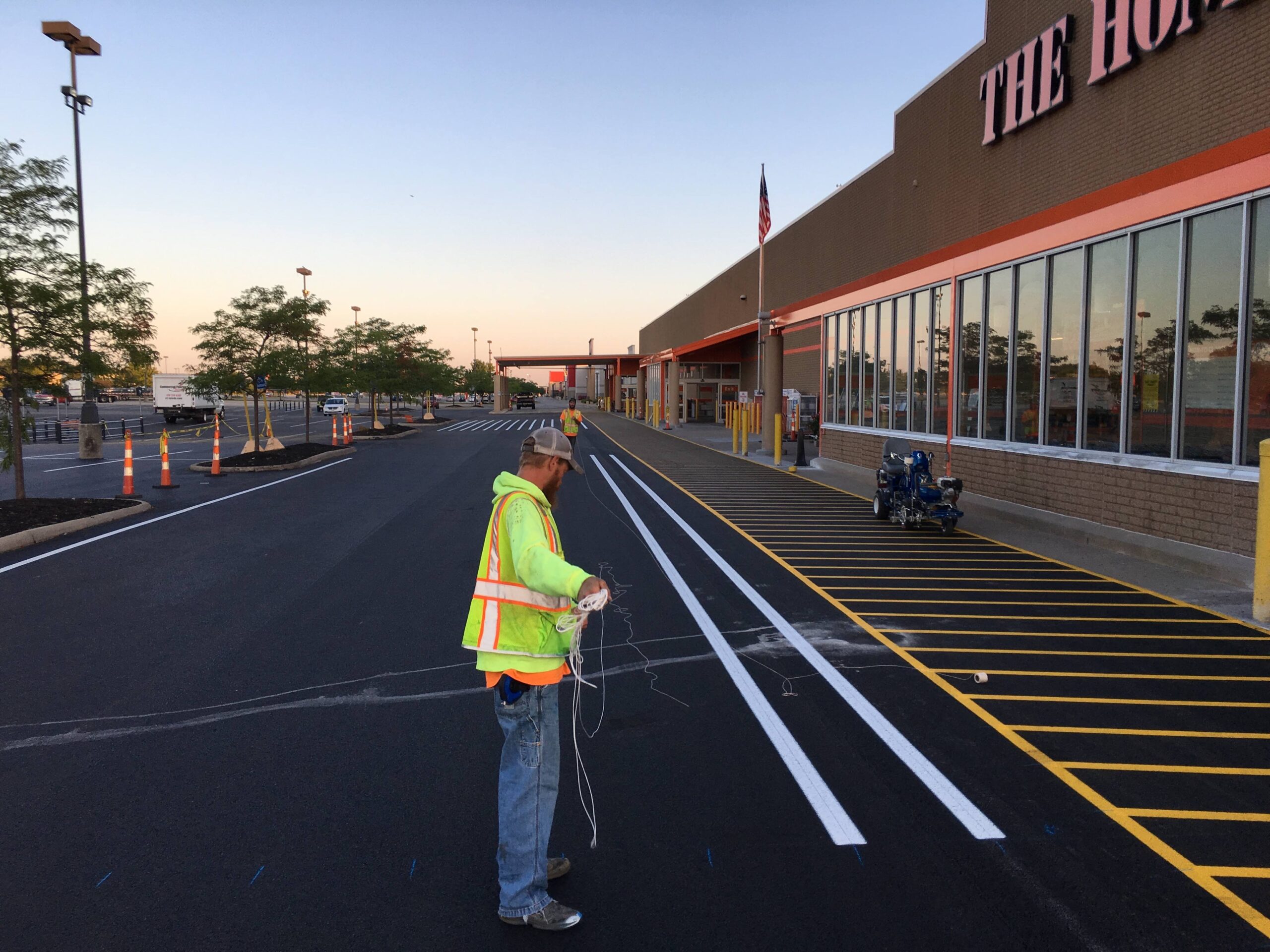 Fresh white parking lines and yellow hatch markings outside a commercial store