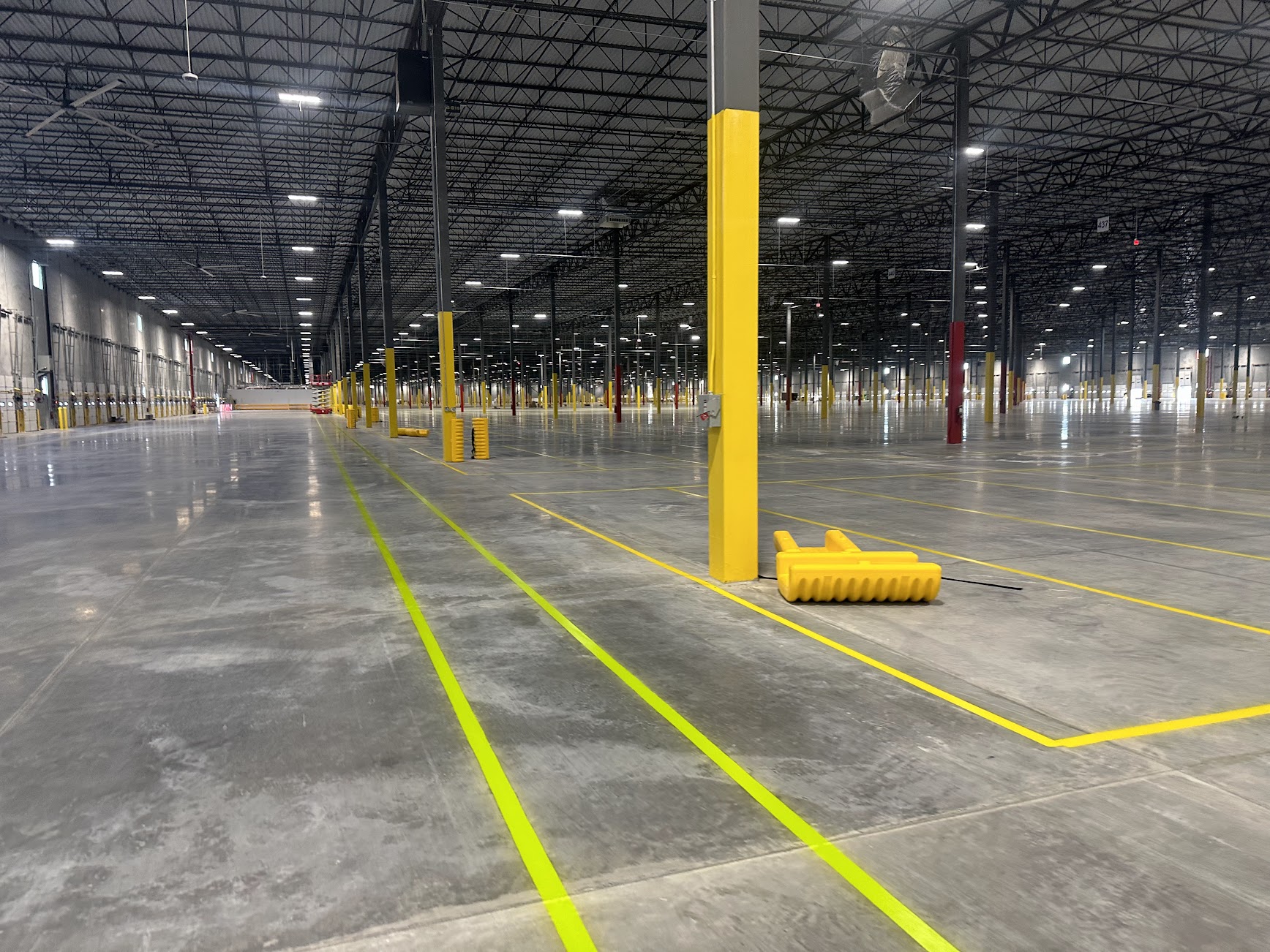 Yellow floor markings inside a large warehouse