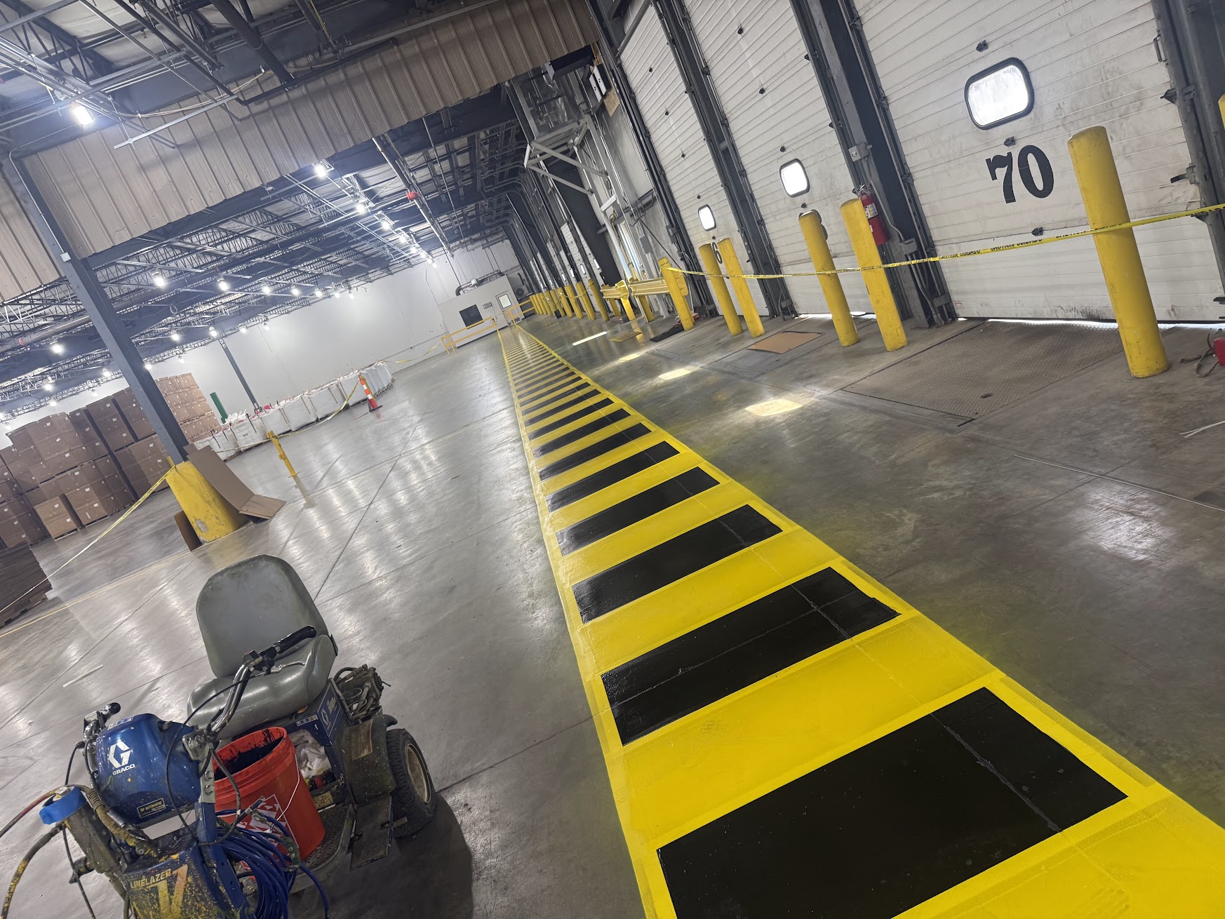 Yellow and black marked route near industrial loading bays