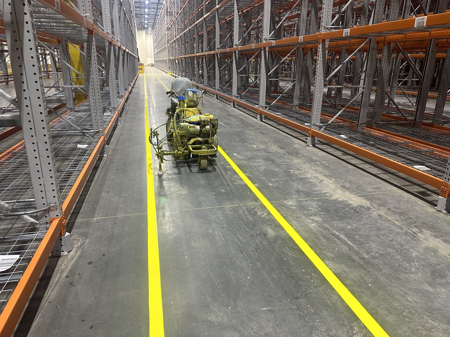 Marked warehouse aisle with industrial racking and equipment