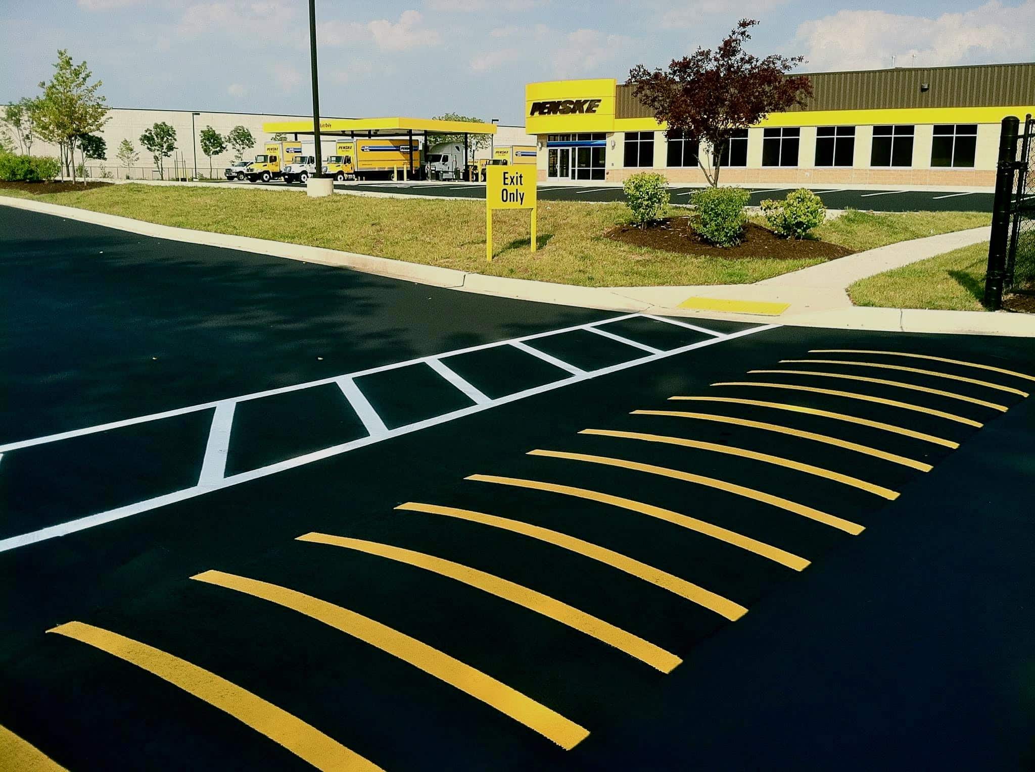 Line striping machine marking a truck terminal parking lot
