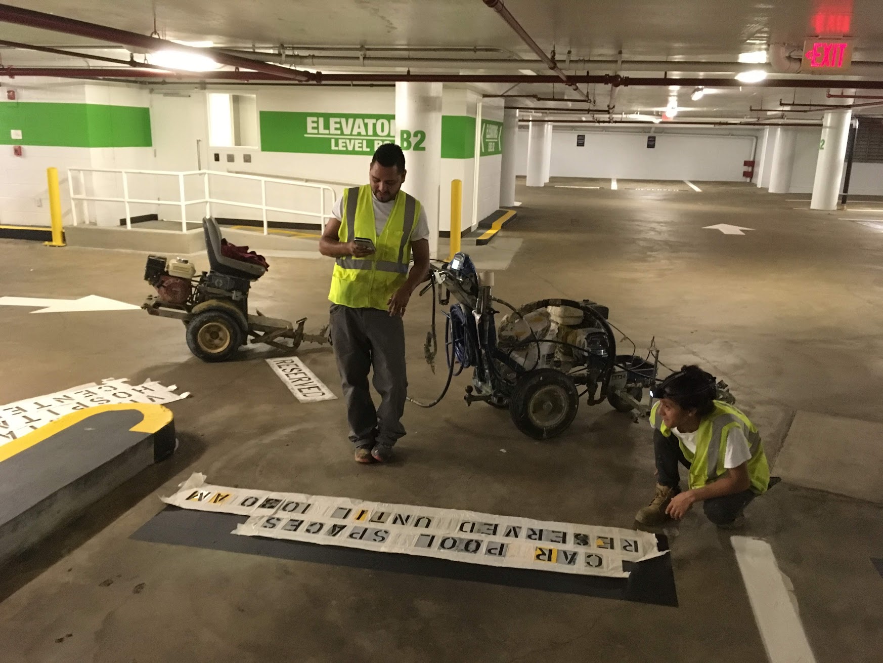 Chicago parking garage striping crew applying custom pavement markings