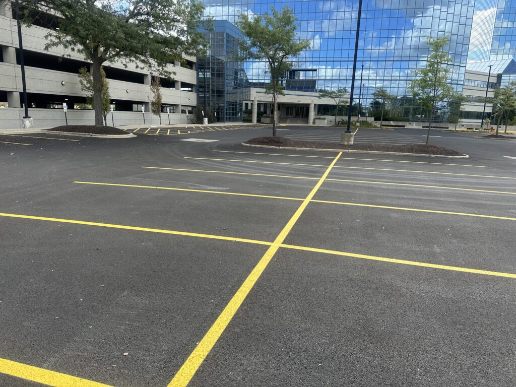 Commercial parking lot striping beside parking garage