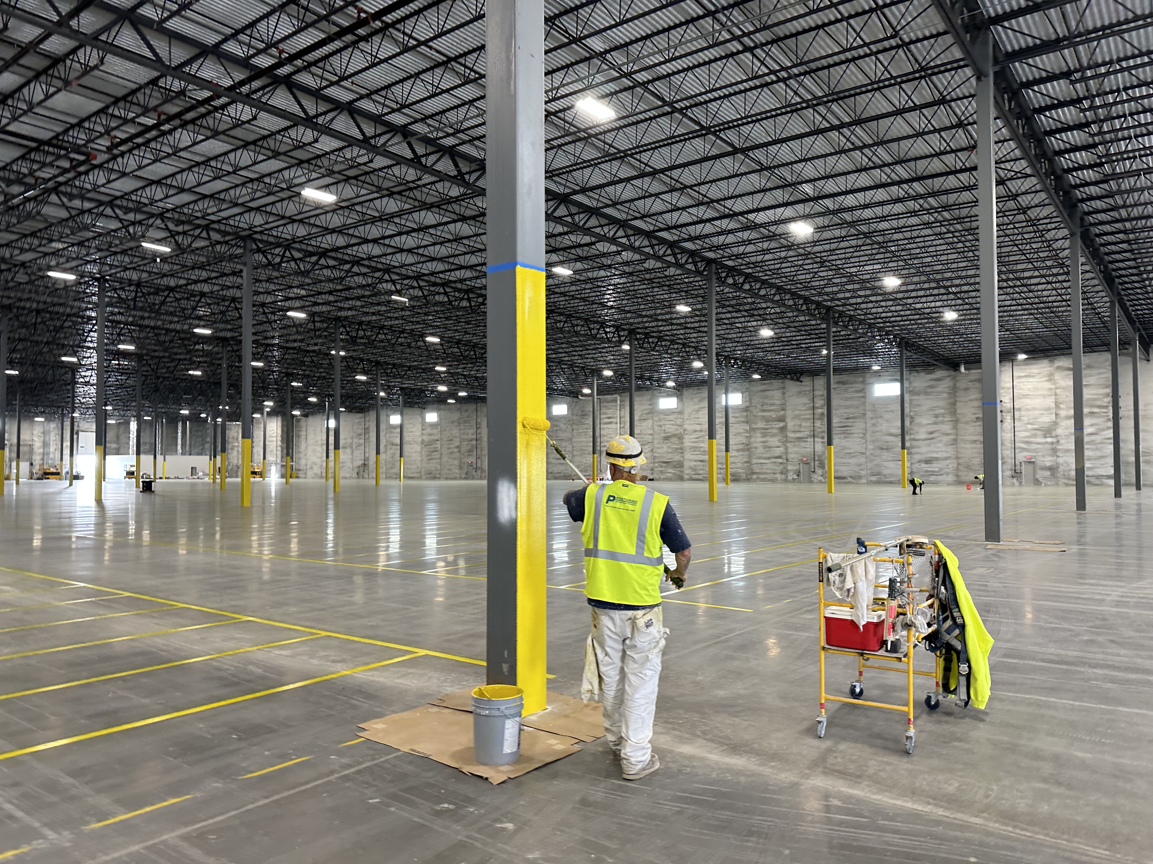 Industrial warehouse floor striping project with marked traffic lanes