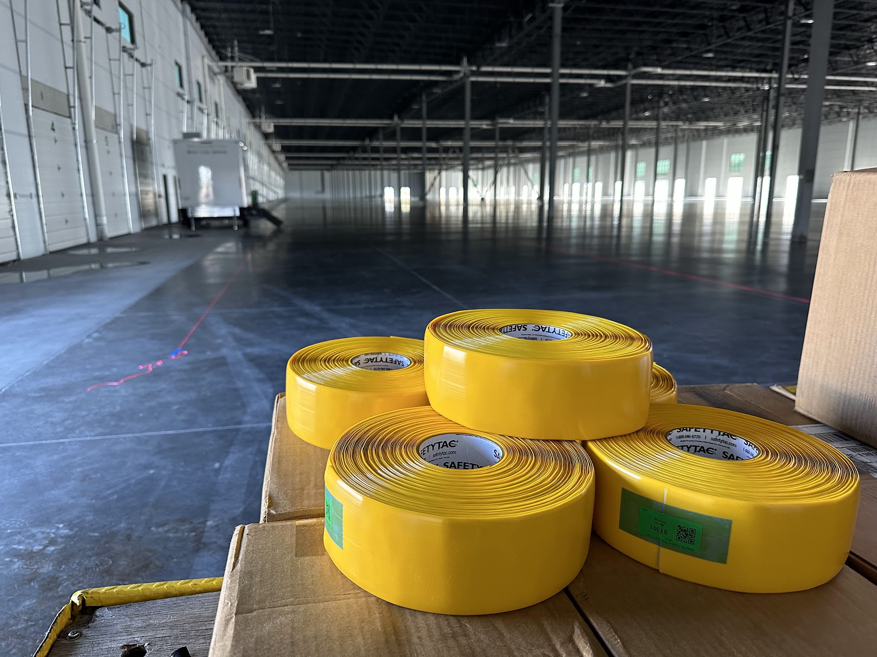 Safety floor tape installation aligned with laser layout