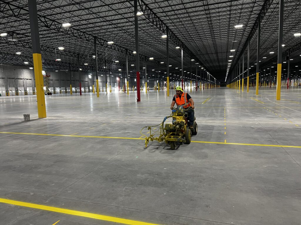 Industrial warehouse floor striping and yellow epoxy markings