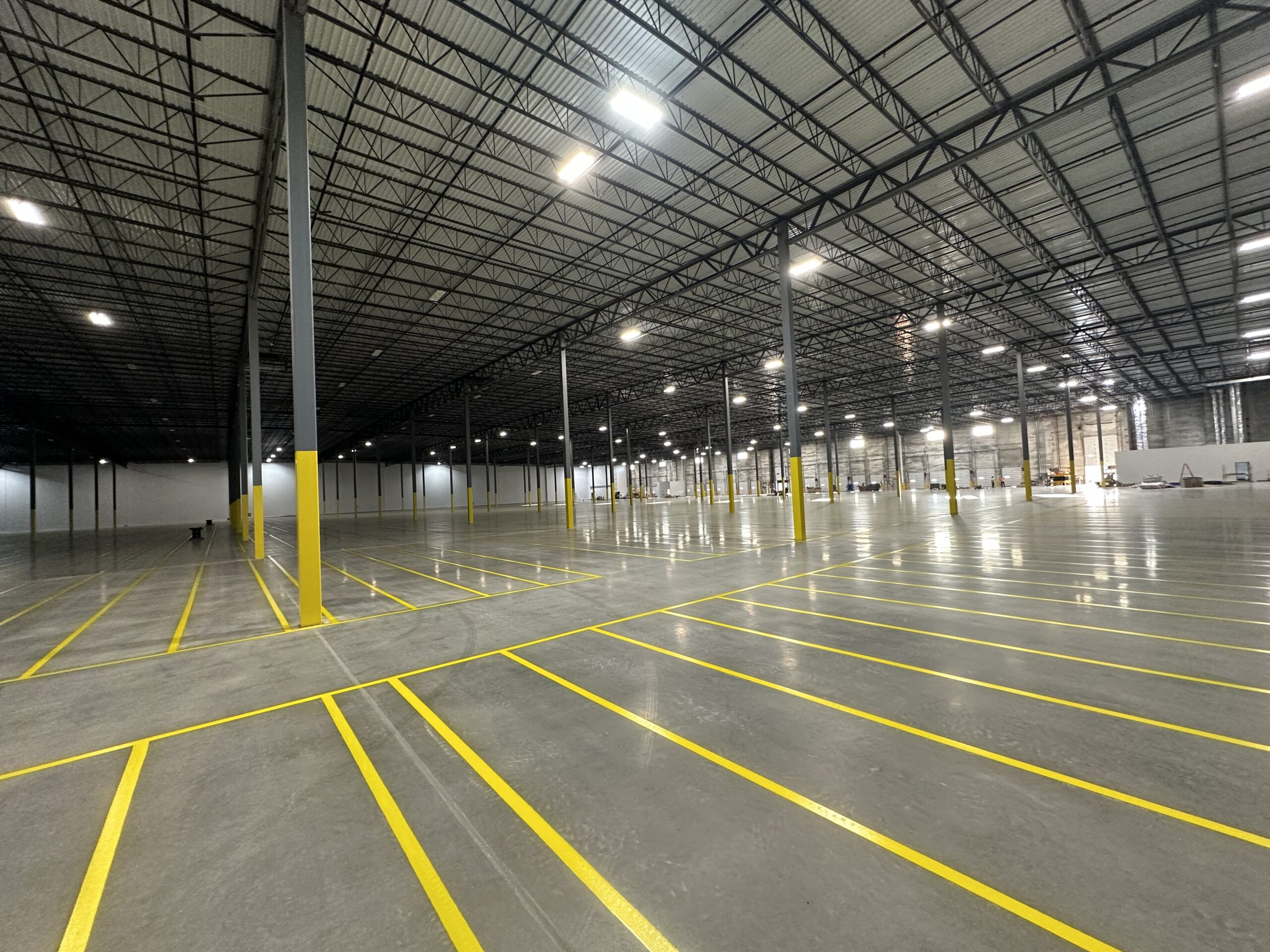 Industrial warehouse floor striping and yellow epoxy markings